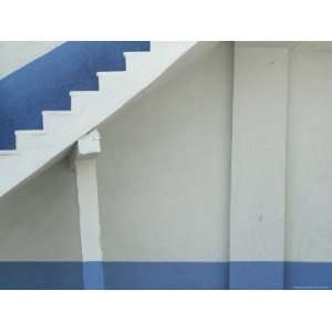  A White Wall and Staircase with Blue Stripes Stretched 