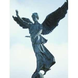  Statue of a Cement Angel Standing on a Ball in Montreal 