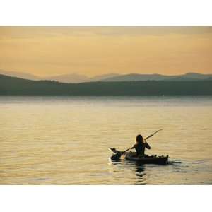 A Kayaker Paddles Across Lake Sebagos Calm Waters in Low 