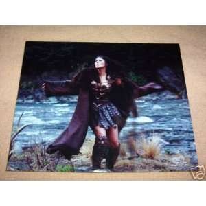  XENA ARMS OUT BY WATER PHOTO LUCY LAWLESS 