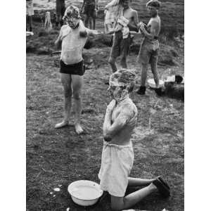  Two Boys from a Boys Club Wash Using Soap and a Small Bowl 